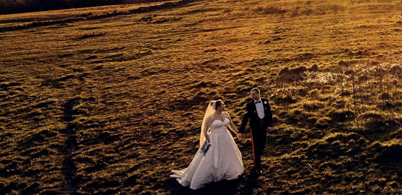 bride and groom walking in the sunset