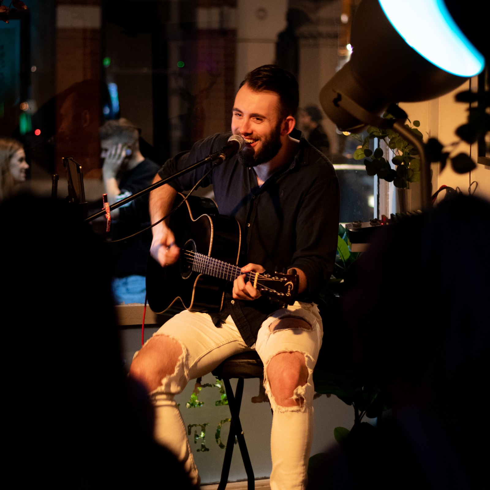 a male singer with guitar performing 